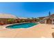 Private pool with lush landscaping, slide, and ample space for lounging in the backyard at 7103 E Medina Ave, Mesa, AZ 85209
