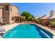 Inviting pool area surrounded by mature landscaping, offering a serene backyard retreat at 7103 E Medina Ave, Mesa, AZ 85209
