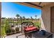 Charming balcony with a cozy seating area overlooking a lush golf course and pool at 7129 E Broadway Rd # 72, Mesa, AZ 85208