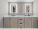 Modern bathroom vanity with double sinks, sleek black fixtures, and illuminated mirrors at 7129 E Broadway Rd # 72, Mesa, AZ 85208