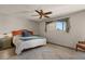 Comfortable bedroom with a ceiling fan, neutral walls, and a large window at 7129 E Broadway Rd # 72, Mesa, AZ 85208
