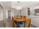 Bright dining room featuring a wooden table with seating for six and modern pendant lighting at 7129 E Broadway Rd # 72, Mesa, AZ 85208