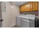 Functional laundry room featuring a washer, dryer, and overhead storage cabinets at 7129 E Broadway Rd # 72, Mesa, AZ 85208