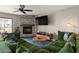 Inviting living room boasts a stone fireplace, ceiling fan, and comfortable green sectional at 7129 E Broadway Rd # 72, Mesa, AZ 85208
