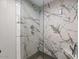 Luxurious shower features stunning marble tiling, a glass enclosure, and modern showerhead at 7129 E Broadway Rd # 72, Mesa, AZ 85208