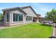 View of backyard with grass, patio and lush landscaping at 7149 E Plata Ave, Mesa, AZ 85212