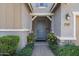 Inviting covered entryway with a blue front door and decorative landscaping, offering a warm welcome at 7149 E Plata Ave, Mesa, AZ 85212