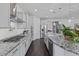 Modern kitchen featuring stainless steel appliances, granite countertops, and a stylish white backsplash at 7149 E Plata Ave, Mesa, AZ 85212