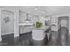 Open-concept kitchen with white cabinets, granite countertops, stainless steel appliances, and an island with seating at 7149 E Plata Ave, Mesa, AZ 85212