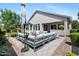 Back patio with outdoor seating and manicured landscaping at 7149 E Plata Ave, Mesa, AZ 85212
