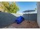Small gravel backyard with stucco wall, palm tree, and an umbrella at 7506 N 47Th Dr, Glendale, AZ 85301