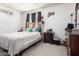 Bedroom featuring a cozy bed with comfortable bedding and dark wood accents at 7506 N 47Th Dr, Glendale, AZ 85301