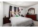 Cozy bedroom featuring neutral walls, carpet, wood furniture, and a comfortable bed at 7506 N 47Th Dr, Glendale, AZ 85301