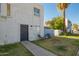 Exterior of a two-story apartment featuring a small front yard, walkway, and chairs at 7506 N 47Th Dr, Glendale, AZ 85301