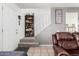 Entryway to living room features shelving, a carpeted staircase, and tile flooring at 7506 N 47Th Dr, Glendale, AZ 85301