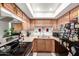 Functional kitchen layout with a range and ample counter space and wooden cabinets at 7506 N 47Th Dr, Glendale, AZ 85301