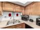 A kitchen view featuring light countertops and raised-panel wooden cabinetry at 7506 N 47Th Dr, Glendale, AZ 85301