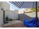 Outdoor patio with door, storage, gravel, and partial shade from an umbrella at 7506 N 47Th Dr, Glendale, AZ 85301