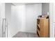 Empty room with a shelf, grey carpet, and white walls at 7506 N 47Th Dr, Glendale, AZ 85301