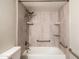 Well-lit bathroom showcasing tub and shower combo with accessible grab bars and neutral tile surround at 7920 E Camelback Rd # 110, Scottsdale, AZ 85251