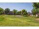 Lush green golf course with sand traps, mature trees, and apartments with a mountain in the background at 7920 E Camelback Rd # 110, Scottsdale, AZ 85251