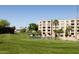 Scenic view of golf course and lake with a condo building in the background, sunny day at 7920 E Camelback Rd # 110, Scottsdale, AZ 85251