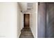 Hallway featuring wood-look floors and barn doors, leading to a contrasting dark brown door at 7920 E Camelback Rd # 110, Scottsdale, AZ 85251