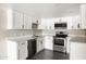 Bright updated kitchen with stainless steel appliances, white cabinets and countertop at 7920 E Camelback Rd # 110, Scottsdale, AZ 85251