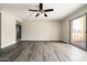 Spacious living room with wood-look floors, ceiling fan, and sliding glass doors to outdoor patio at 7920 E Camelback Rd # 110, Scottsdale, AZ 85251