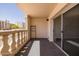Outdoor patio with sliding door, carpeted floor, and decorative railing with apartment building view at 7920 E Camelback Rd # 110, Scottsdale, AZ 85251