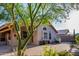 Charming home featuring a well-maintained backyard with brick pavers and manicured greenery at 7940 W Taro Ln, Glendale, AZ 85308