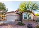 Attractive single-story home with a red tile roof, desert landscaping, and a two-car garage at 7940 W Taro Ln, Glendale, AZ 85308