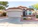 Charming single-story home featuring a well-maintained landscape, red tile roof, and a two-car garage at 7940 W Taro Ln, Glendale, AZ 85308