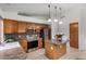 Well-lit kitchen features tile floors, granite countertops, stainless steel appliances, and an island at 7940 W Taro Ln, Glendale, AZ 85308