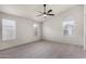 Spacious main bedroom is well-lit by natural light through three windows and features a ceiling fan at 7940 W Taro Ln, Glendale, AZ 85308