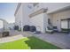 Spacious backyard featuring artificial grass, pavers, and a covered patio area at 7978 W Zoe Ella Way, Peoria, AZ 85382