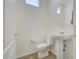 Cozy powder room featuring a pedestal sink, oval mirror, and wood-look flooring at 7978 W Zoe Ella Way, Peoria, AZ 85382
