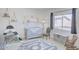 Charming Bedroom with a teepee, crib, rocking chair, and decorative elements at 7978 W Zoe Ella Way, Peoria, AZ 85382