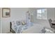 Bright bedroom with a window and desk, featuring a patterned comforter and a wall mirror at 7978 W Zoe Ella Way, Peoria, AZ 85382