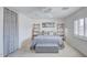 Bright bedroom with neutral walls, white trim, light carpet, and stylish furnishings at 7978 W Zoe Ella Way, Peoria, AZ 85382