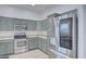 Spacious kitchen with stainless steel fridge, updated appliances, light countertops, and painted cabinets at 7978 W Zoe Ella Way, Peoria, AZ 85382