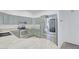Well-equipped kitchen features stainless steel appliances, granite countertops, and stylish sage-colored cabinetry at 7978 W Zoe Ella Way, Peoria, AZ 85382