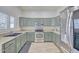 Bright kitchen showcasing sleek appliances, ample cabinet space, and stone countertops at 7978 W Zoe Ella Way, Peoria, AZ 85382