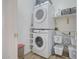 Functional laundry room with stacked washer and dryer, plus ample storage shelves at 7978 W Zoe Ella Way, Peoria, AZ 85382