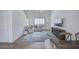 Bright living space with high ceilings, stylish lighting, and a comfortable sofa, adjacent to the dining area at 7978 W Zoe Ella Way, Peoria, AZ 85382