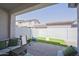 Covered patio with comfortable seating area, artificial grass, and outdoor play area at 7978 W Zoe Ella Way, Peoria, AZ 85382