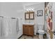 Bathroom with wooden vanity, framed mirror, decorative tile and neutral decor at 8036 N 17Th Dr, Phoenix, AZ 85021