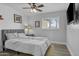 Comfortable bedroom with ceiling fan, large window, and neutral decor at 8036 N 17Th Dr, Phoenix, AZ 85021