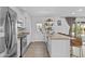 Bright kitchen with white cabinets, granite countertops, stainless steel appliances, and a peninsula with bar seating at 8036 N 17Th Dr, Phoenix, AZ 85021