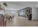 Open-concept living area with wood-style flooring, neutral walls, and a seamless flow to the dining and kitchen spaces at 8036 N 17Th Dr, Phoenix, AZ 85021